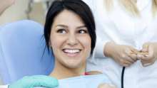 woman smiling in chair at dentist