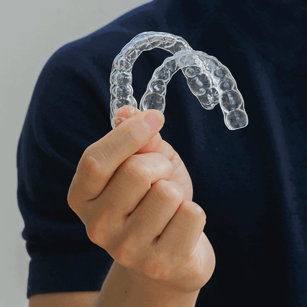 Fort worth man holding teeth aligner